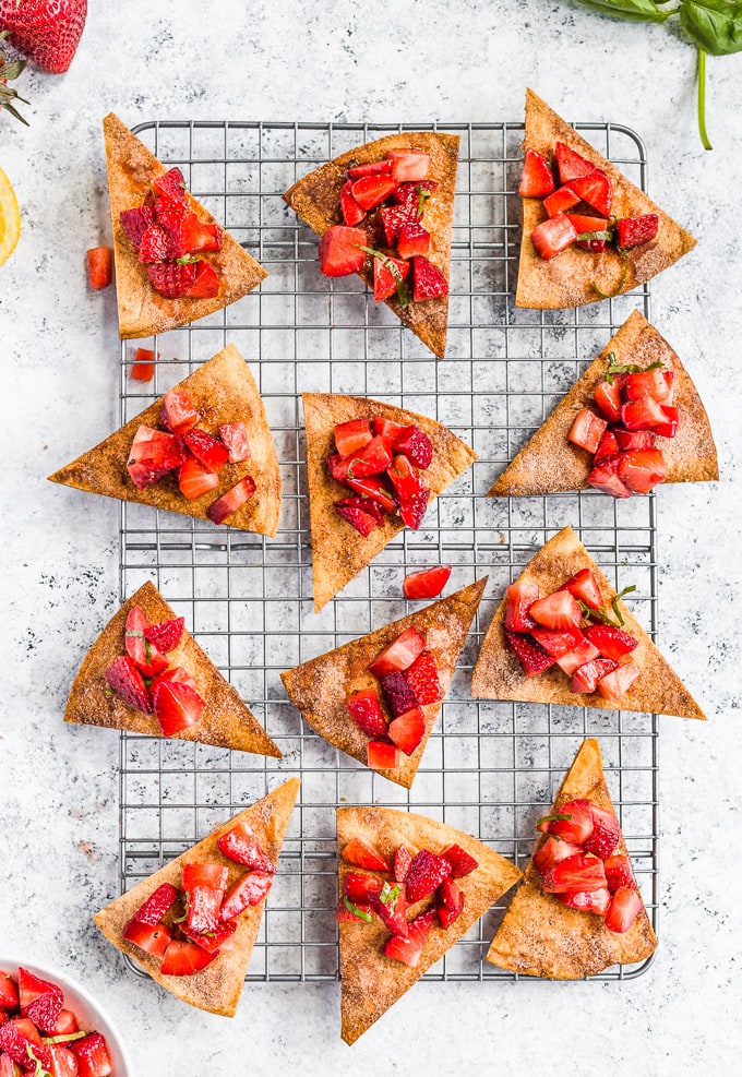 Cinnamon sugar tortilla chips topped with strawberry salsa, on a baking rack