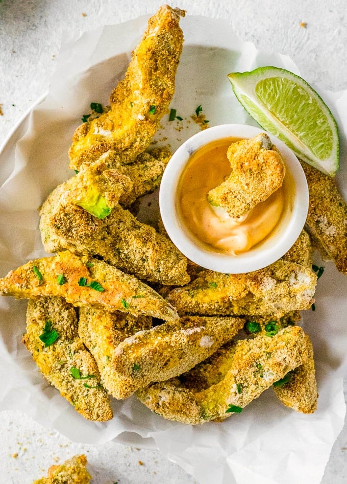 close view of a bowl of avocado fries with dip
