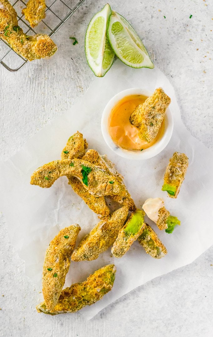 Avocado Fries being dipped into dip