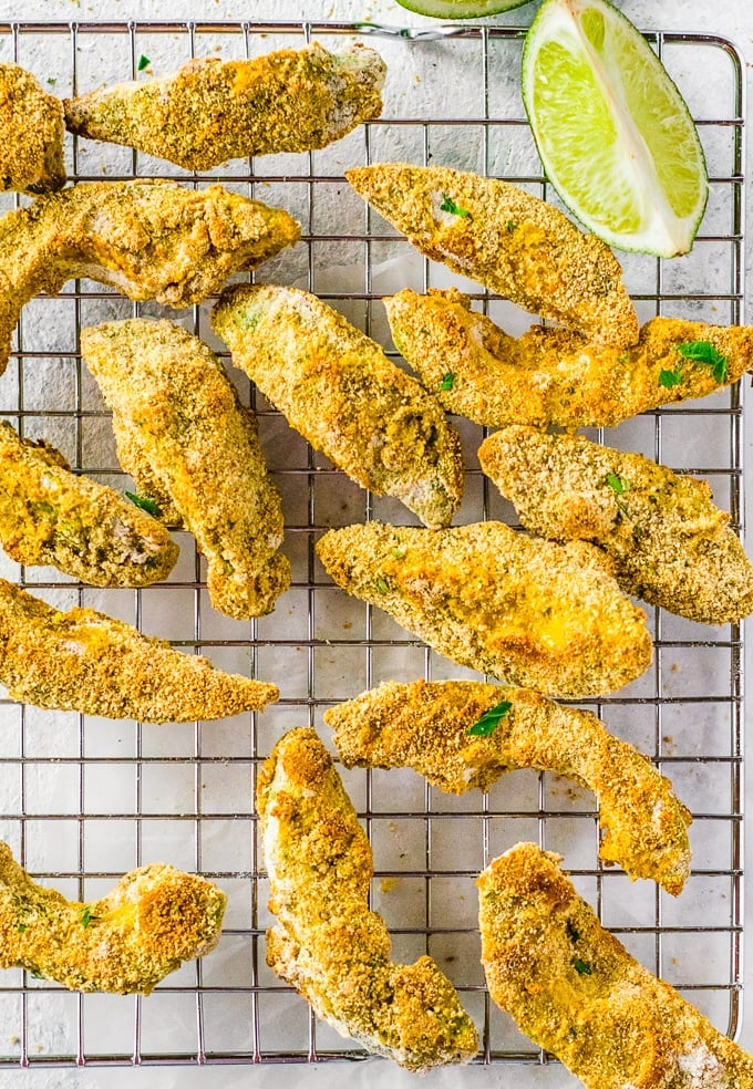 avocado fries on a wire rack with lime wedge