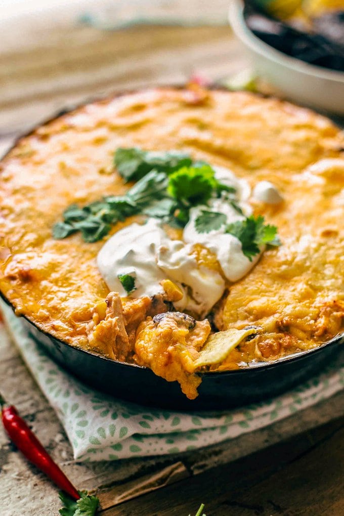 Enchilada dip topped with sour cream and cilantro