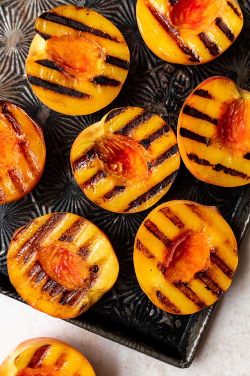 grilled peaches on baking sheet