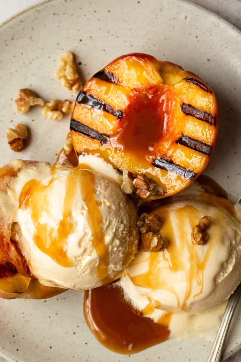 up close grilled peaches with ice cream and caramel sauce