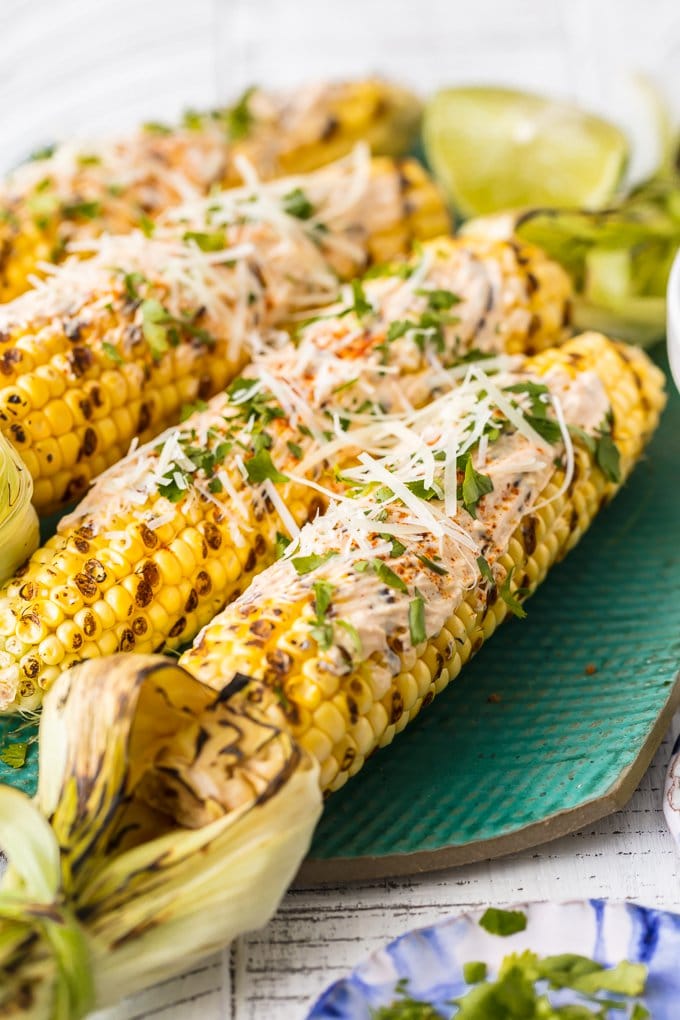 mexican corn grilled and topped with cheese, cilantro, mayo, and more