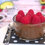 avocado chocolate mousse in a bowl with raspberries.