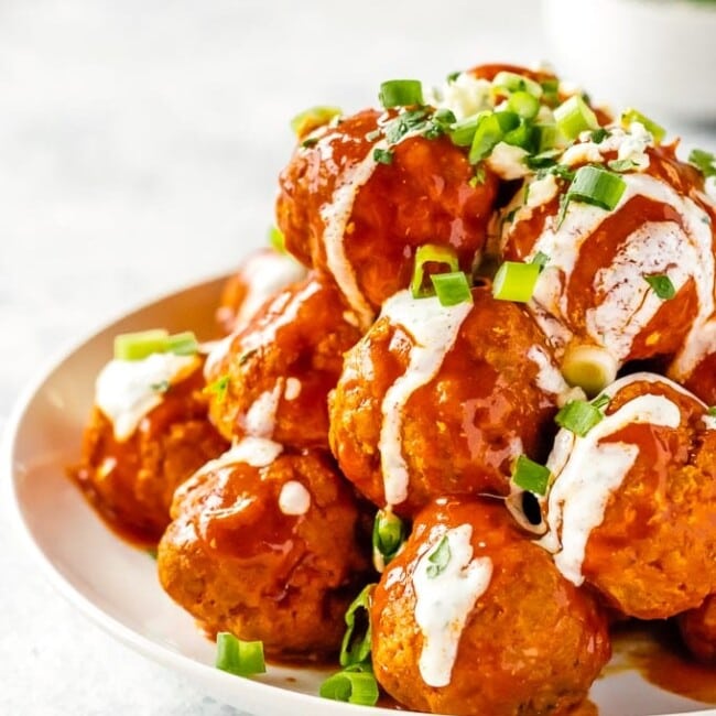 Buffalo Chicken Meatballs are one of our very favorite party appetizers. These Blue Cheese Stuffed Meatballs are relatively healthy, SO flavorful, and sure to please. If you're not sure what to serve for your next tailgating party, this Buffalo Chicken Meatballs Recipe is just the thing. Serve with Homemade Ranch!