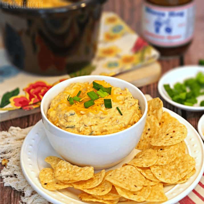 Chicken dip and chips on a table.