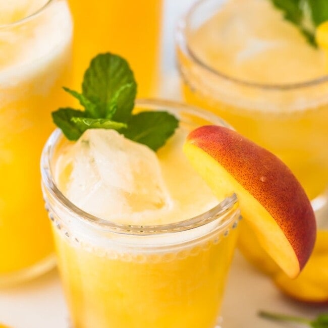 Peach Lemonade is our go-to summer drink! This easy peach drink is made with only 2 ingredients, both frozen so you can make this icy cold drink in minutes. This recipe can be served non-alcoholic to share with everyone, or you can turn it into a delicious peach cocktail with just a bit of vodka. This refreshing drink was just made for Summer. I'm in love!