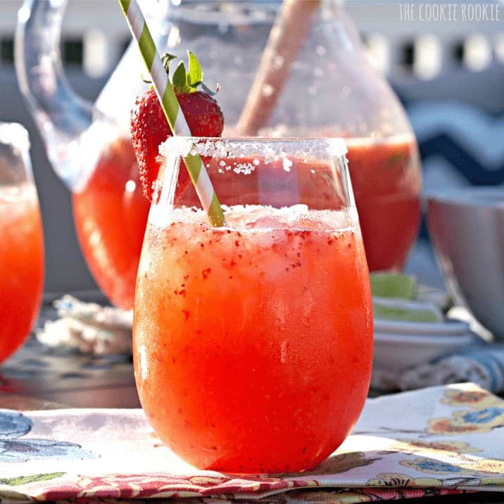 Strawberry Margarita Punch - The Cookie Rookie A glass of margarita punch on a table.
