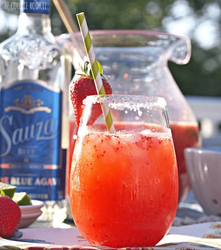 Strawberry Margarita Punch - The Cookie Rookie A glass of strawberry margarita punch with a straw.