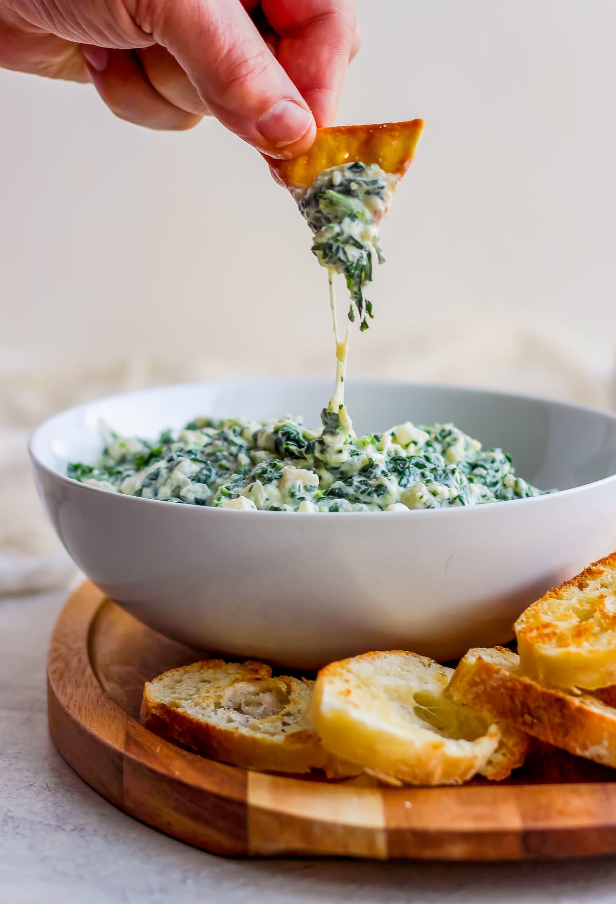 Crockpot Skinny Parmesan Spinach Dip is a delicious and healthy(er) way to enjoy your next tailgate! The perfect appetizer! So fun to not have to feel bad about this classic recipe!