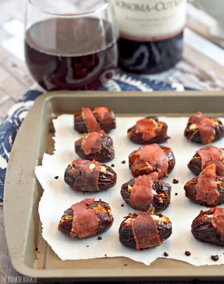 Wine and stuffed-date appetizers.