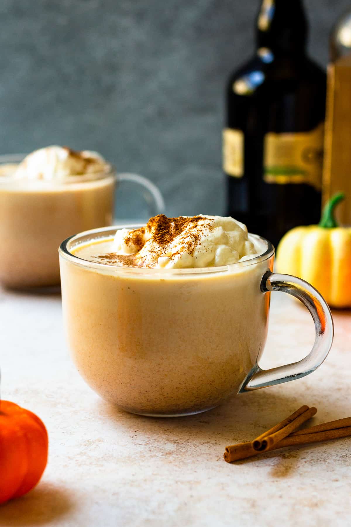 Hot pumpkin cocktail in mug with whipped cream.
