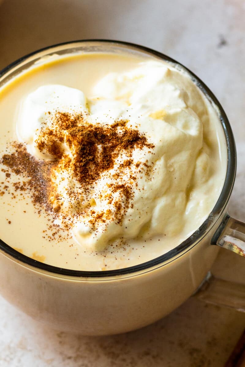 up close hot pumpkin cocktail in mug with whipped cream