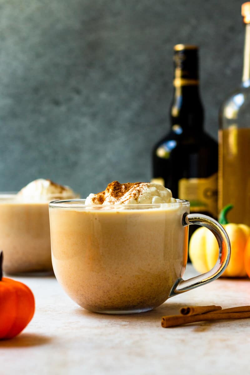 hot pumpkin cocktail in mug with whipped cream