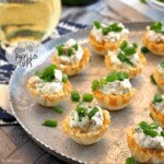phyllo cups topped with green onions on silver platter