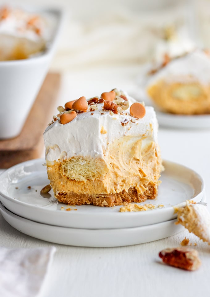 Layers of graham crackers, pumpkin pie mousse, whipped cream, and lady fingers