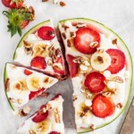 Watermelon Pizza is a delicious and fun sweet treat that everyone will enjoy! Juicy watermelon topped with a low-fat cheesecake sauce, fresh strawberries, bananas, white chocolate chips, and pecans is the ultimate (but still indulgent) healthy dessert. This refreshing cheesecake watermelon pizza is an easy summer dessert you'll be eating all season long!