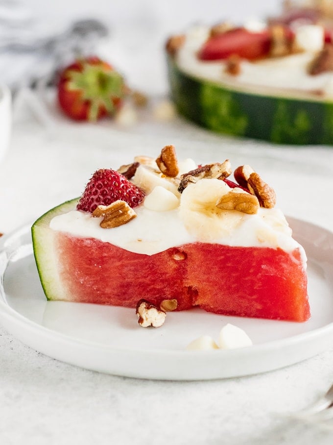 Slice of watermelon topped with low-fat cheesecake sauce