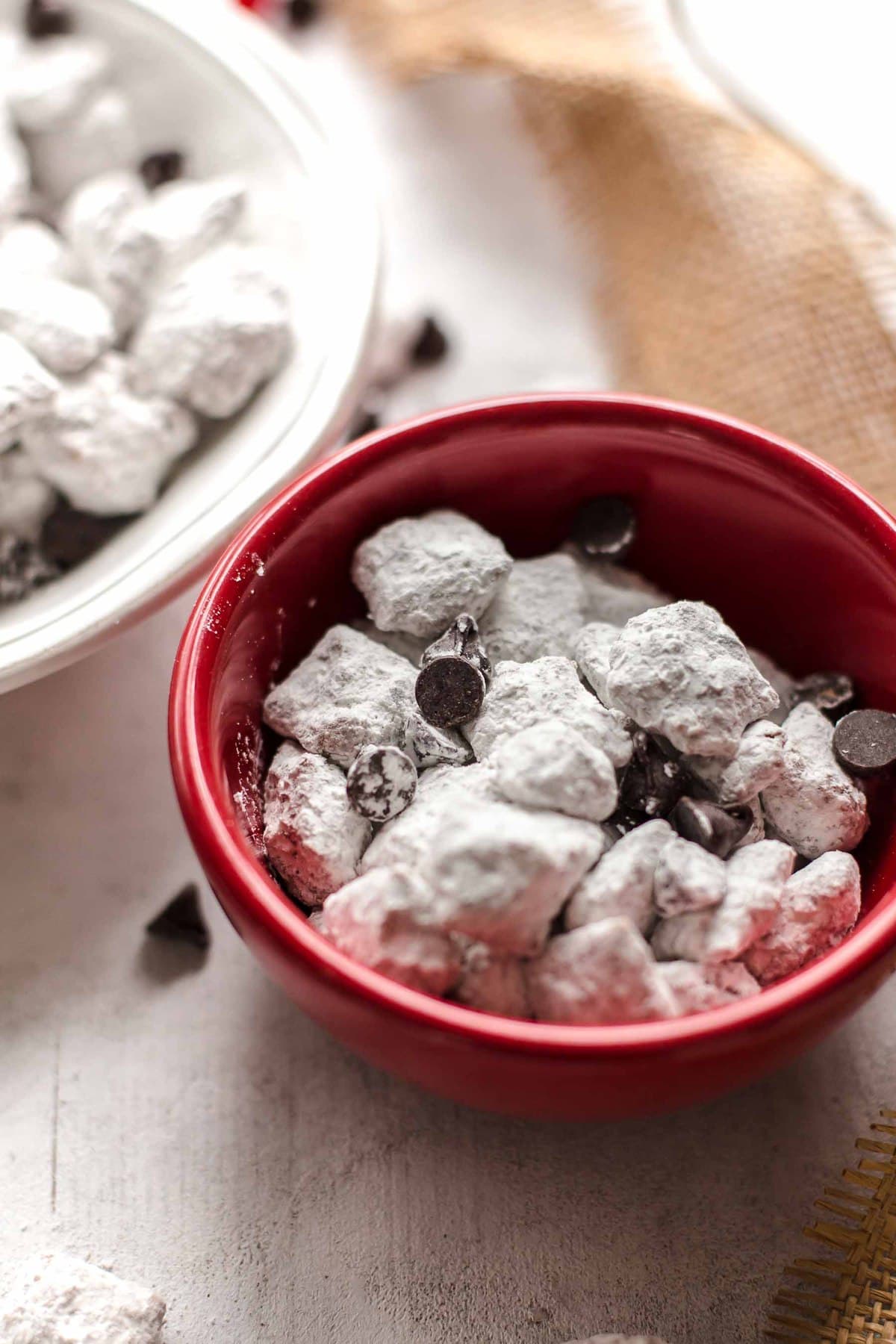 small red bowl of puppy chow chex mix