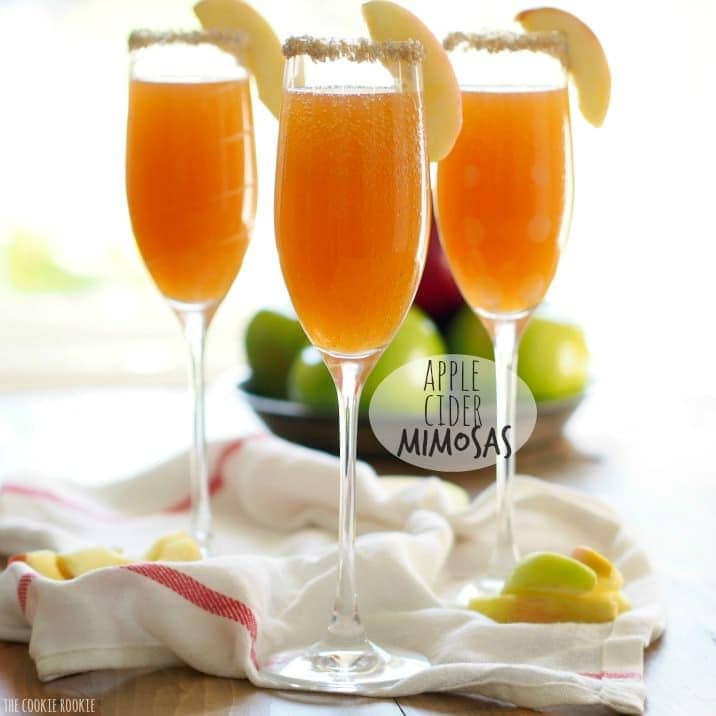 Apple Cider Mimosas are simple, delicious and perfect for fall! You deserve such a fun and bubbly treat once in a while. Thanksgiving is the perfect time for this Apple Cider Cocktail, especially one as easy and tasty as this. I love a good mimosa recipe, and this is my favorite one for the holidays! View of three Apple Cider Mimosas, garnished with apple slices and rimmed glasses.