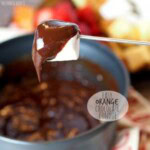 an orange chocolate dip being poured into a pan.