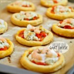 Shrimp and goat cheese tarts on a wooden board