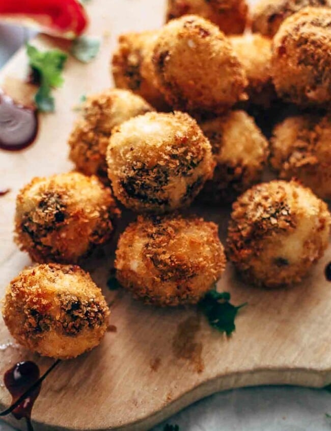 Fried Goat Cheese Balls are the perfect New Year's Eve appetizer! These goat cheese poppers are stuffed with dried cherries and pecans and then deep fried into a crispy little snack. It's definitely my favorite goat cheese appetizer!