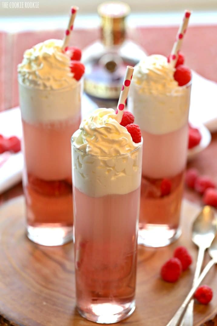 three adult cream sodas topped with whipped cream and a straw