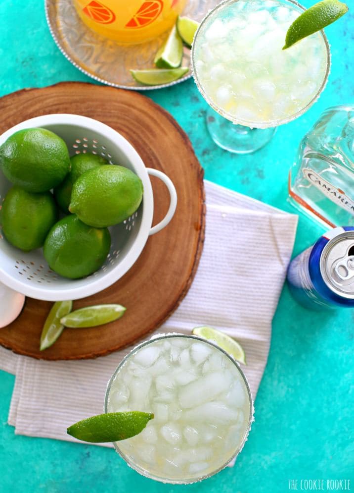 Bowl of lemons, cocktails, and alcohol on a blue table