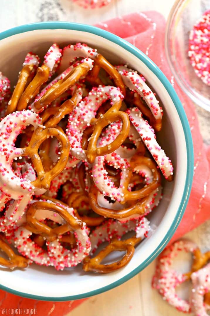 pretzels covered in yogurt with sprinkles in a bowl