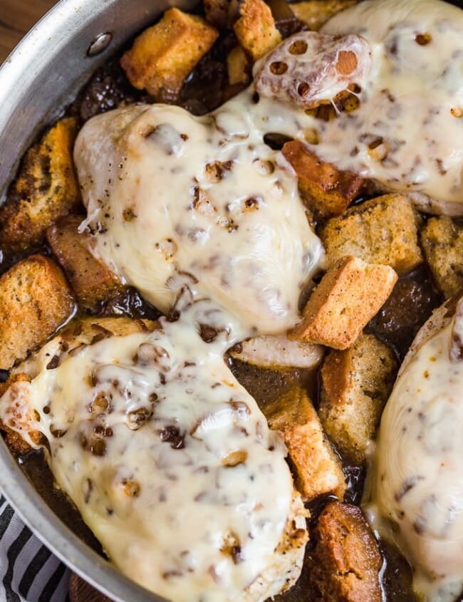 French Onion Chicken is an easy go-to meal the entire family will love! This skillet chicken recipe tastes just like your favorite soup in main course form. French Onion Soup Chicken is chicken breast topped with swiss cheese, french onion soup, croutons, and more cheese!