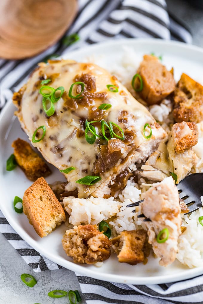 French Onion Chicken is an easy go-to meal the entire family will love! This skillet chicken recipe tastes just like your favorite soup in main course form. French Onion Soup Chicken is chicken breast topped with swiss cheese, french onion soup, croutons, and more cheese! French Onion Chicken