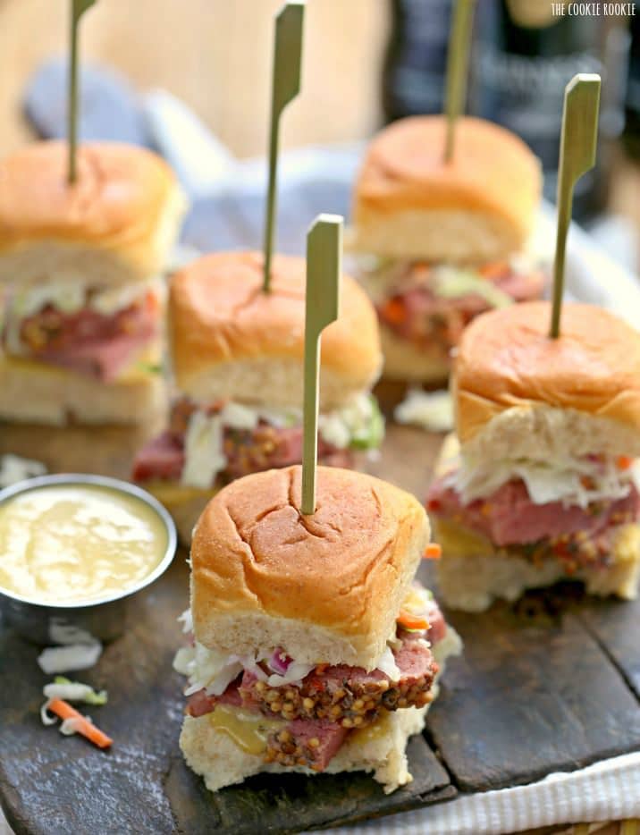 Slow Cooker Corned Beef and Cabbage Sliders with Guinness Mustard on a wooden platter