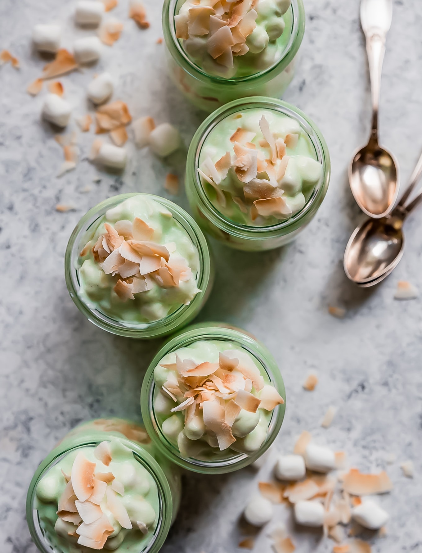 five jars of watergate salad next to spoons