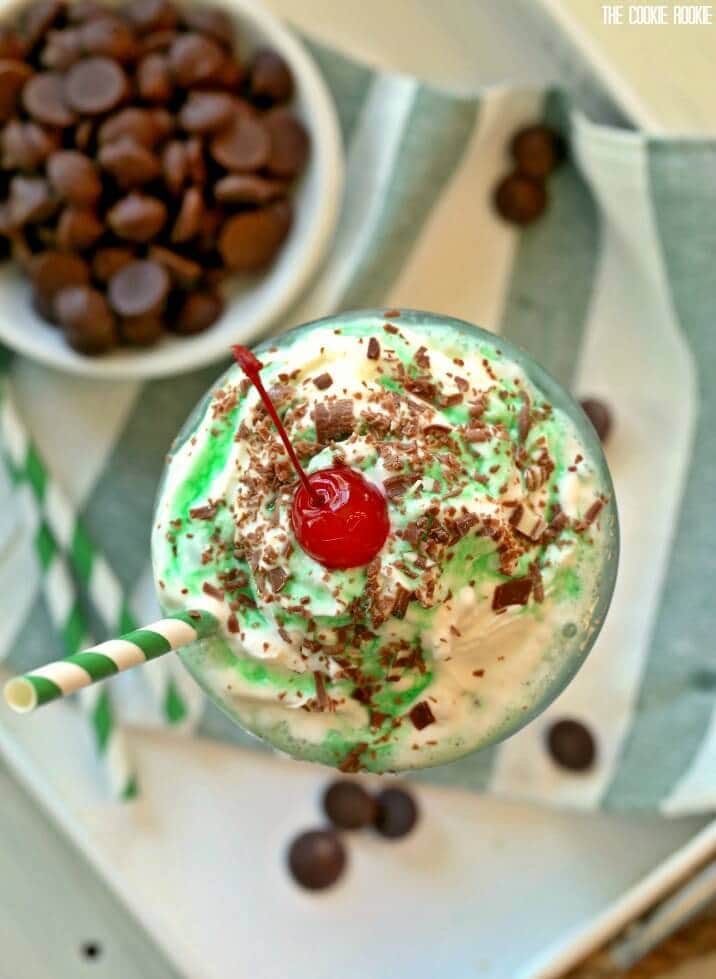 overhead shot of chocolate mint shake topped with a cherry and chocolate shavings
