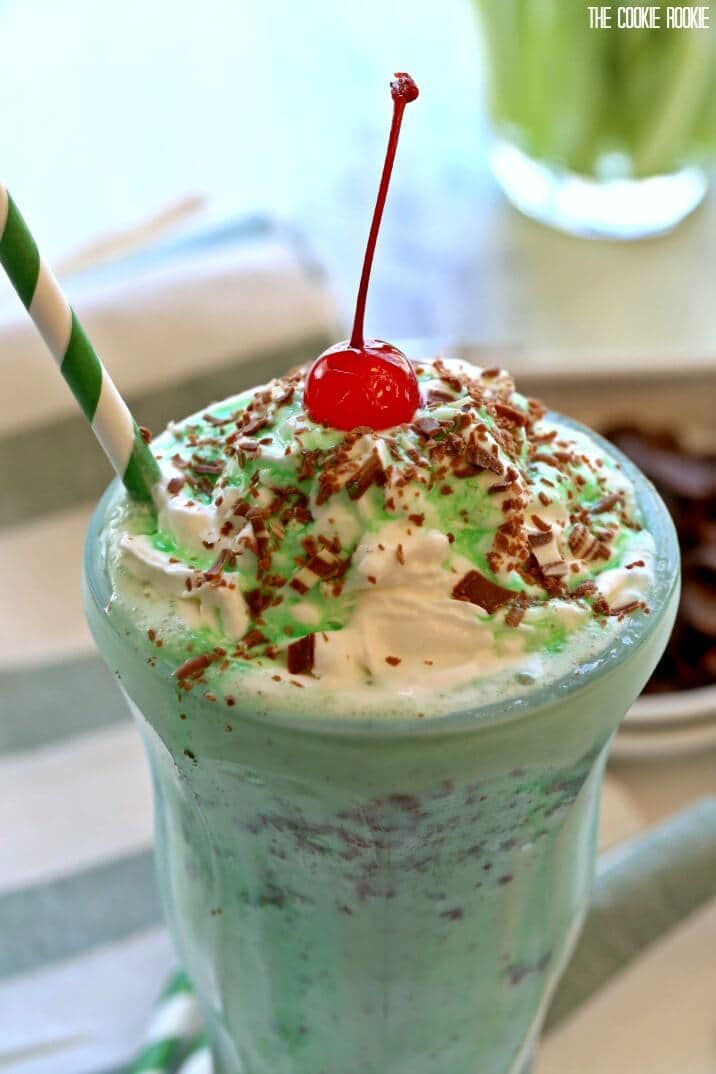 shamrock shake topped with whipped cream, cherry, and chocolate