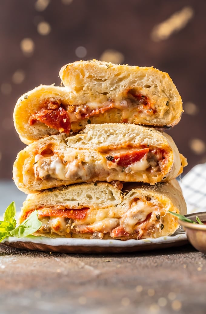 This EASY Stromboli Recipe is one of our go-to weeknight meals the entire family LOVES. Meat Lovers Stromboli is stuffed with juicy sausage, pepperoni, and bacon and loaded with cheese. The crust bakes up crispy on the outside and fluffy on the inside for the ultimate and perfect Stromboli! 