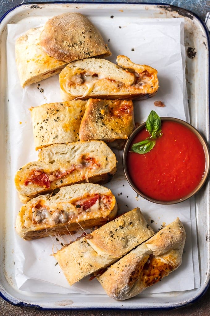 cheesy stromboli slices on a white plate