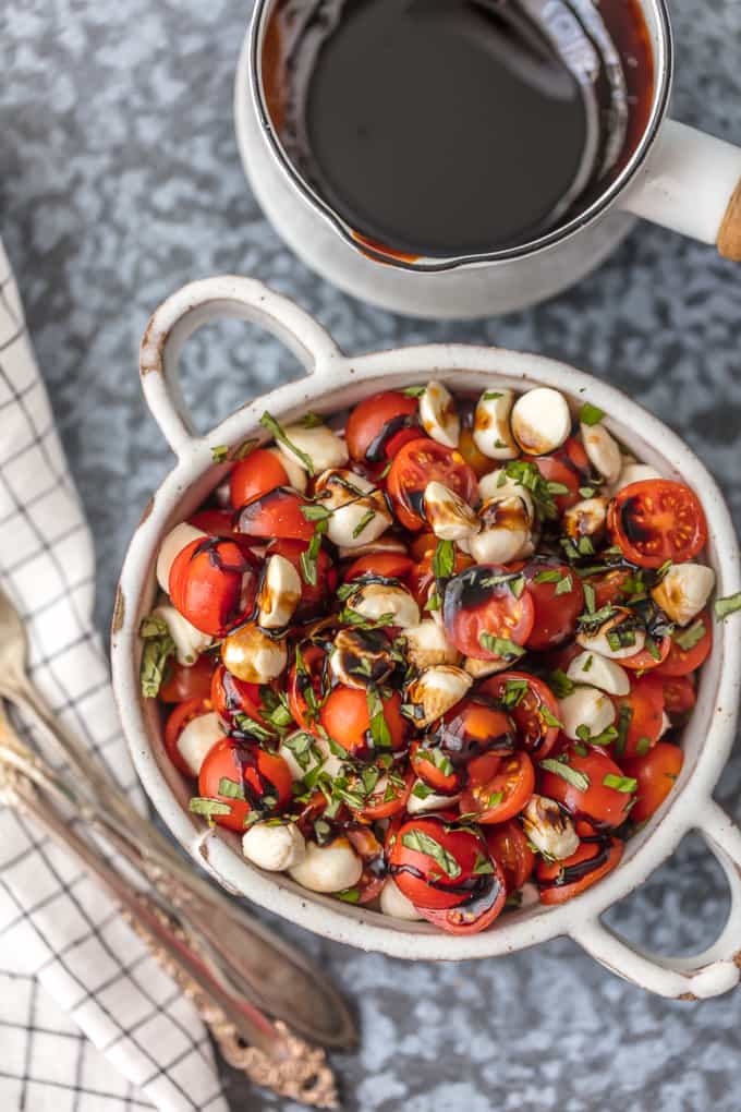 Chopped Caprese Salad is the perfect easy side dish for any BBQ! Simple, delicious, and healthy! Tomato, Mozzarella, Basil, and Balsamic Vinegar. A family favorite!