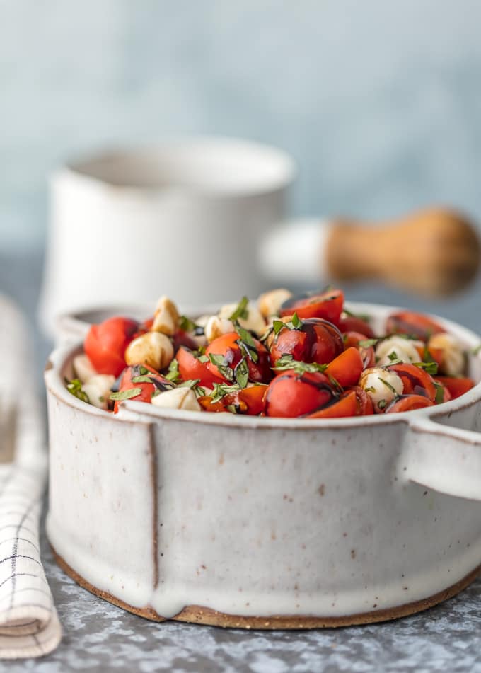 caprese salad topped with fresh basil in a bowl