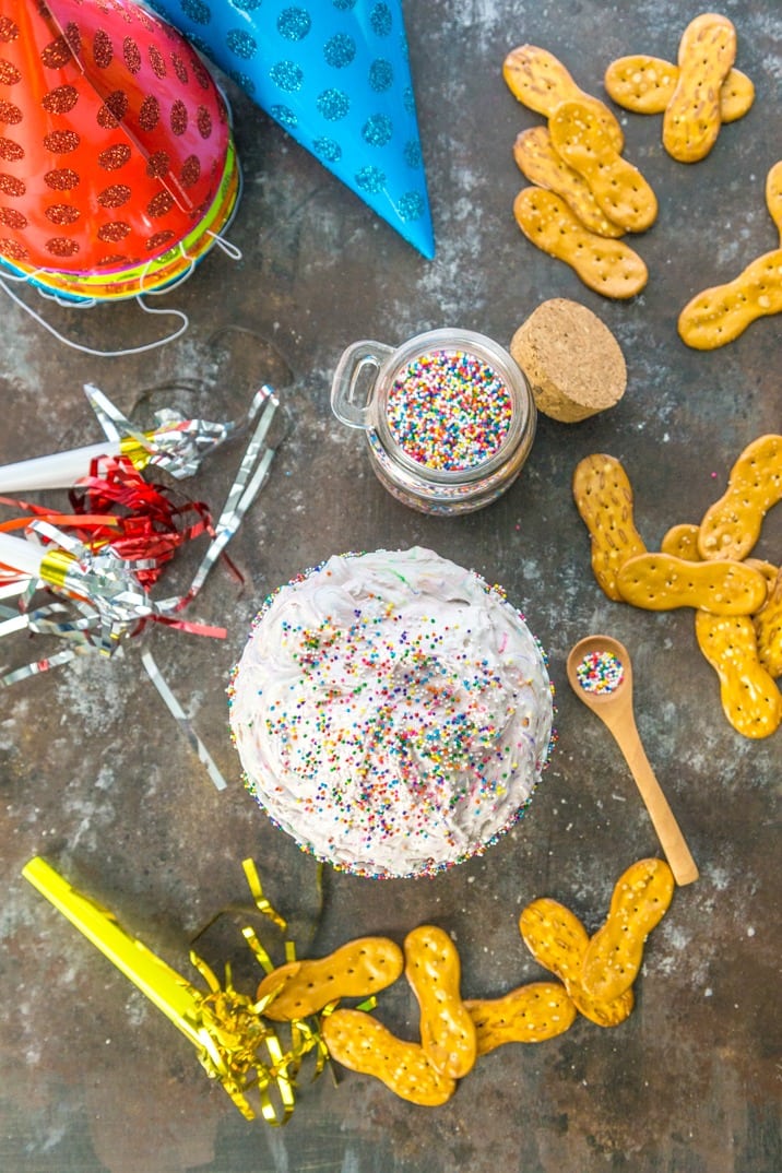 top view of dip with a jar of sprinkles surrounded by pretzel chips