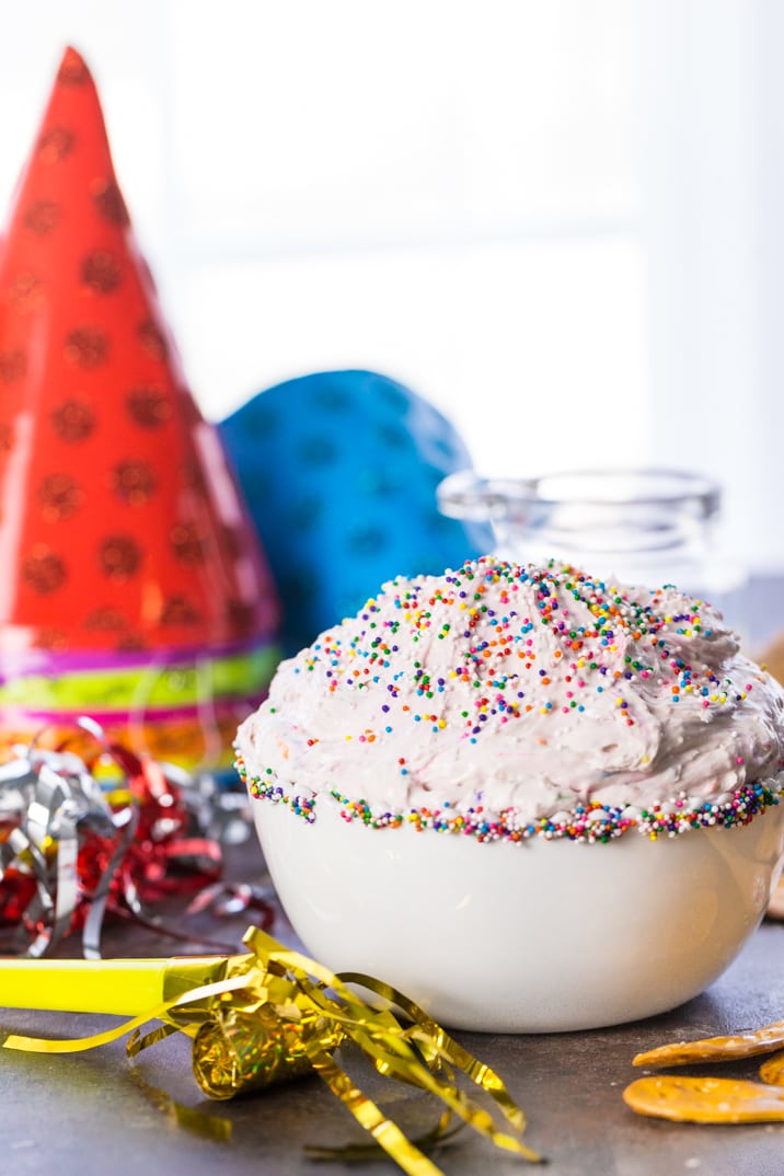 fluffy funfetti cake batter dip in a bowl with sprinkles