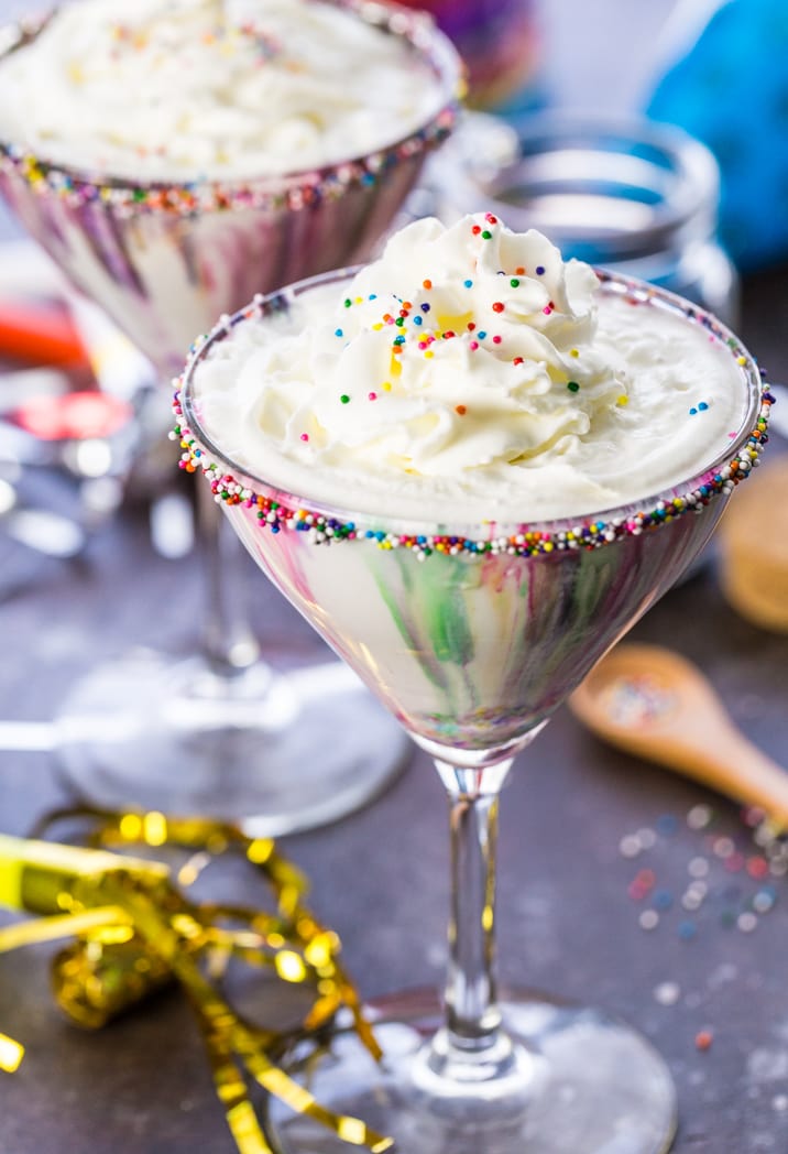 sprinkles and whipped cream on a funfetti martini