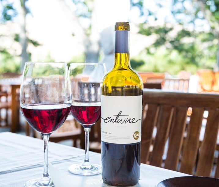 A bottle of wine and a glass of beer on a table, with Spice and Mulled Wine