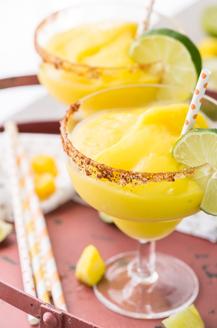 two frozen chili mango margaritas on a table