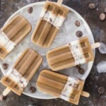 chocolate popsicles on a plate with ice and chocolate chips.