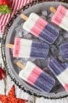 Red White and Blue Smoothie Pops! These popsicles are perfect for the 4th of July or Memorial Day! Celebrate USA with these easy red white and blue pops, so fun!