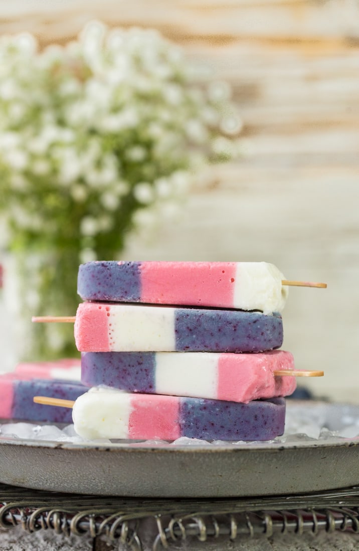 stacked popsicles on a tray of ice