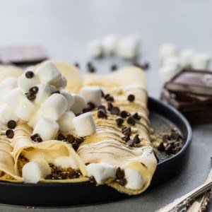 loaded smore crepes on a black plate